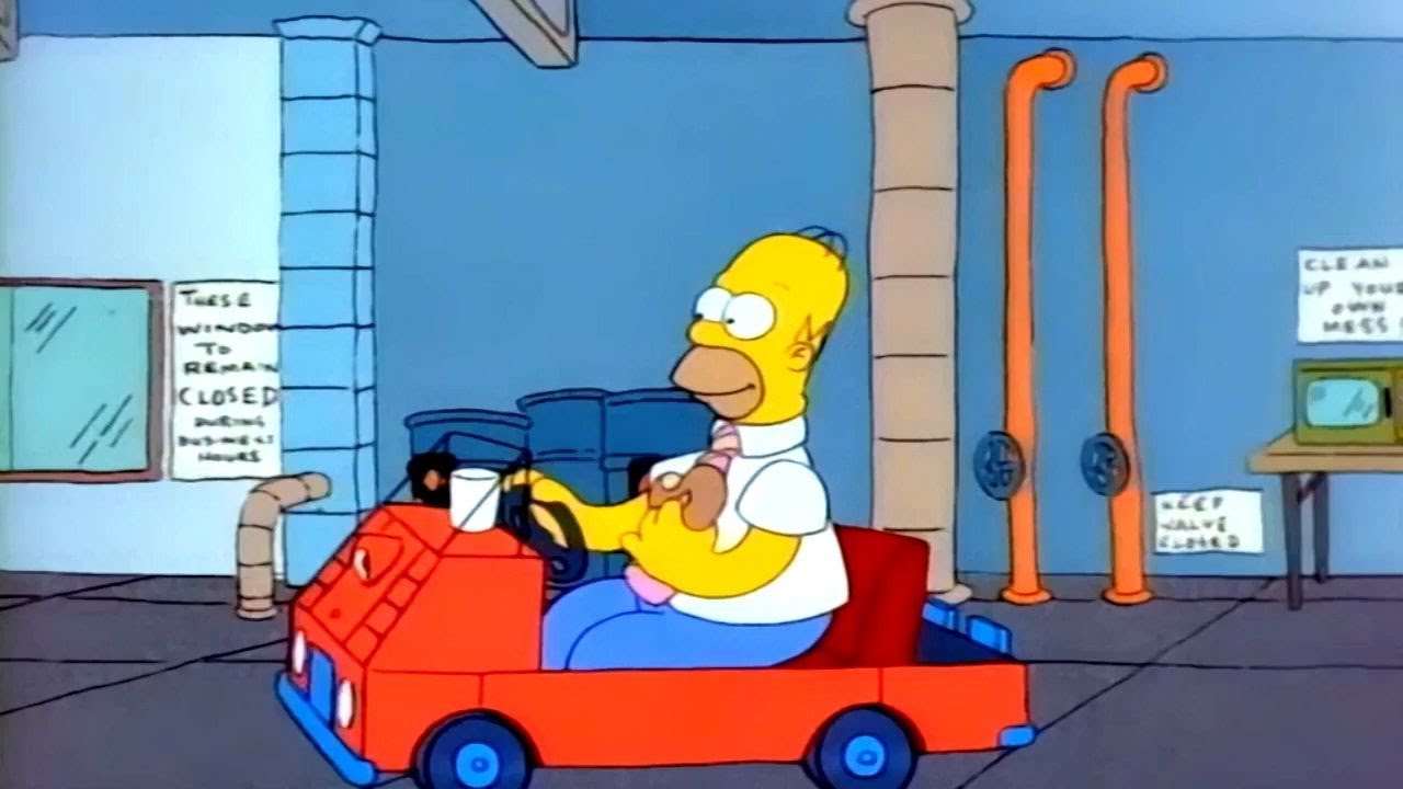 Homer Simpson eating a donut while riding a kart.
